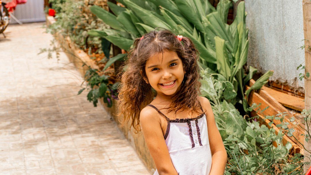 Brazilian woman with curly hair smiling professionally