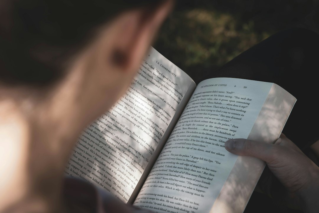 person reading book in morning light